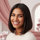 A happy woman in her late 20s with sleek hair, smiling confidently.