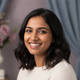 Portrait of a smiling young South Asian woman, exuding happiness and satisfaction.